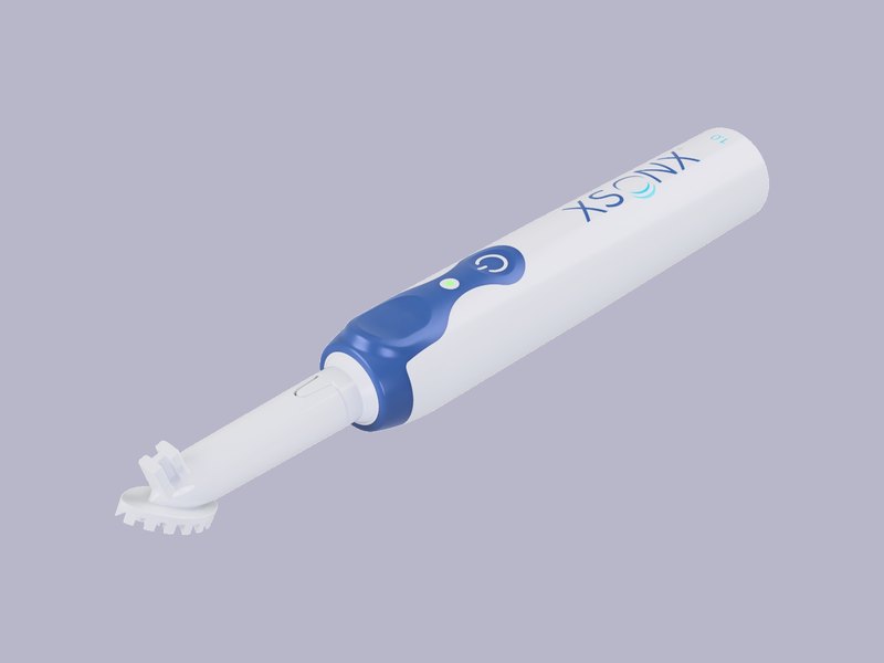XSONX 1.0 ultrasonic debridement handpiece with disposable tip attached